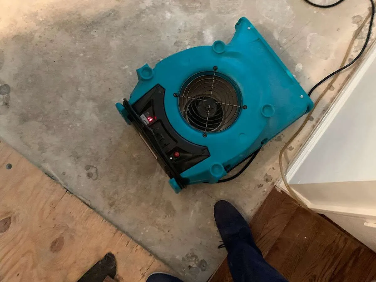 Air mover drying subfloor during Commercial Water Damage Restoration in McHenry